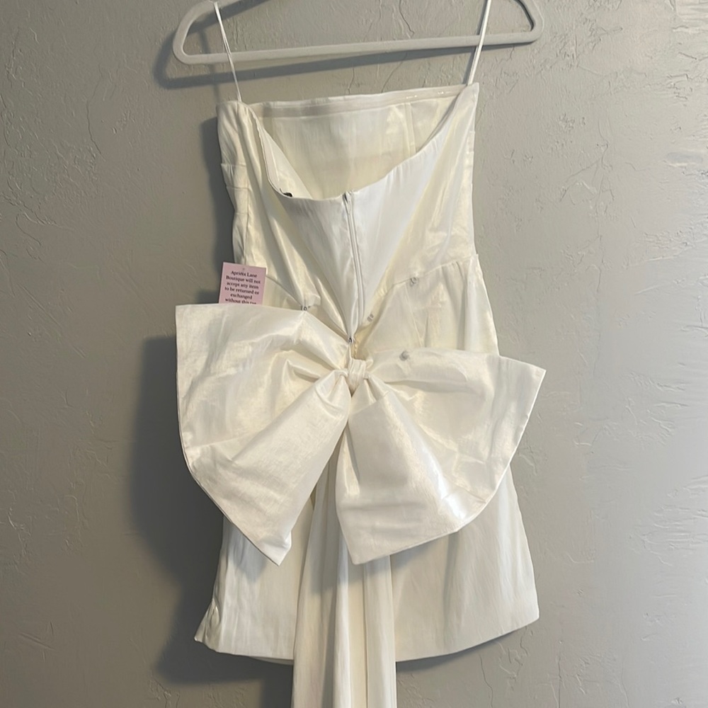 STUNNING white dress with long bow, would be the perfect dress for a bride-to-be